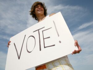 Man holding VOTE sign