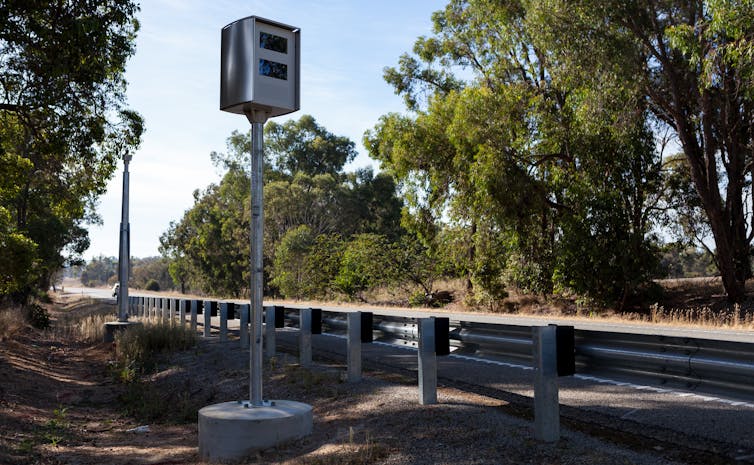 A speed camera sits at the side of a country road in Australia.