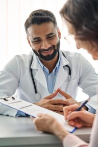 Young,Happy,Indian,Medical,Worker,Therapist,In,White,Robe,Having