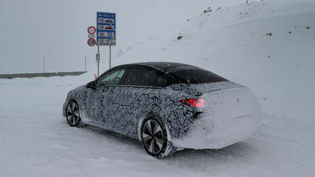 Rear 3/4 view of a camouflaged Mercedes-Benz CLA EV prototype