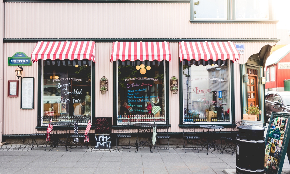 the outside of a small bistro with writing on the windows