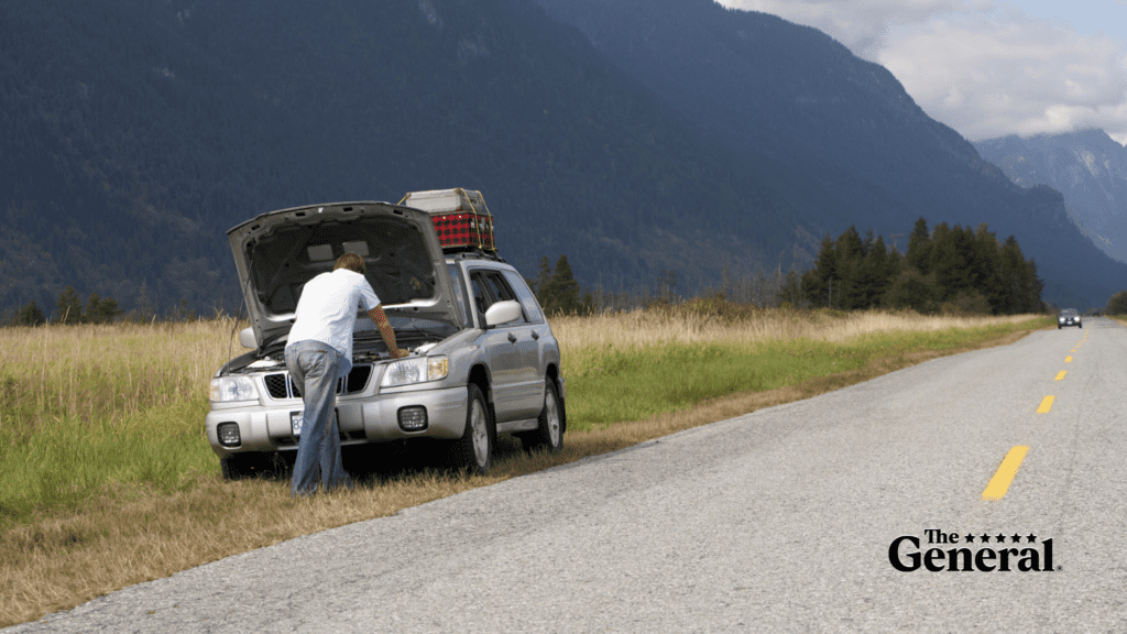 Man inspecting his car, under the hood, trying to figure out why his car won