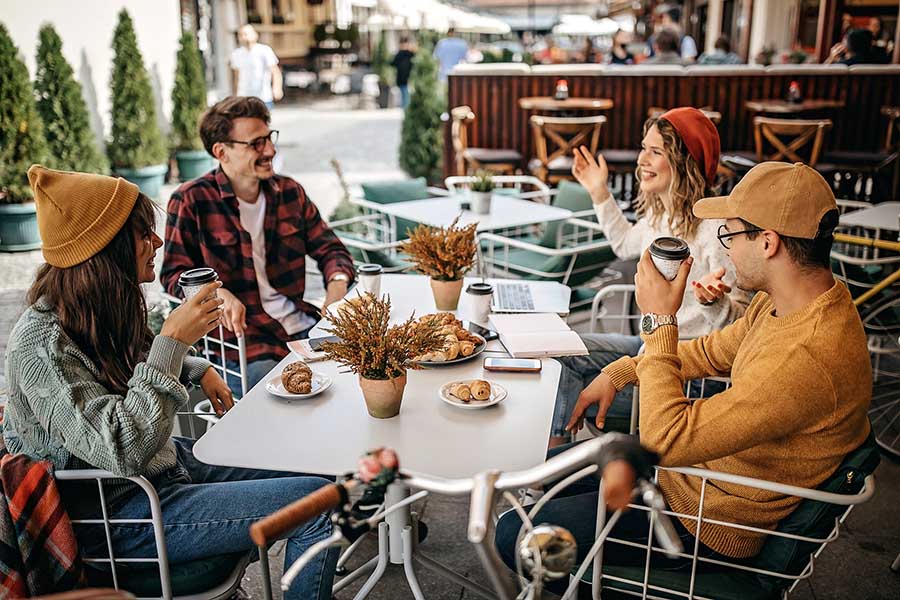 Friends drinking coffee at an outdoor cafe