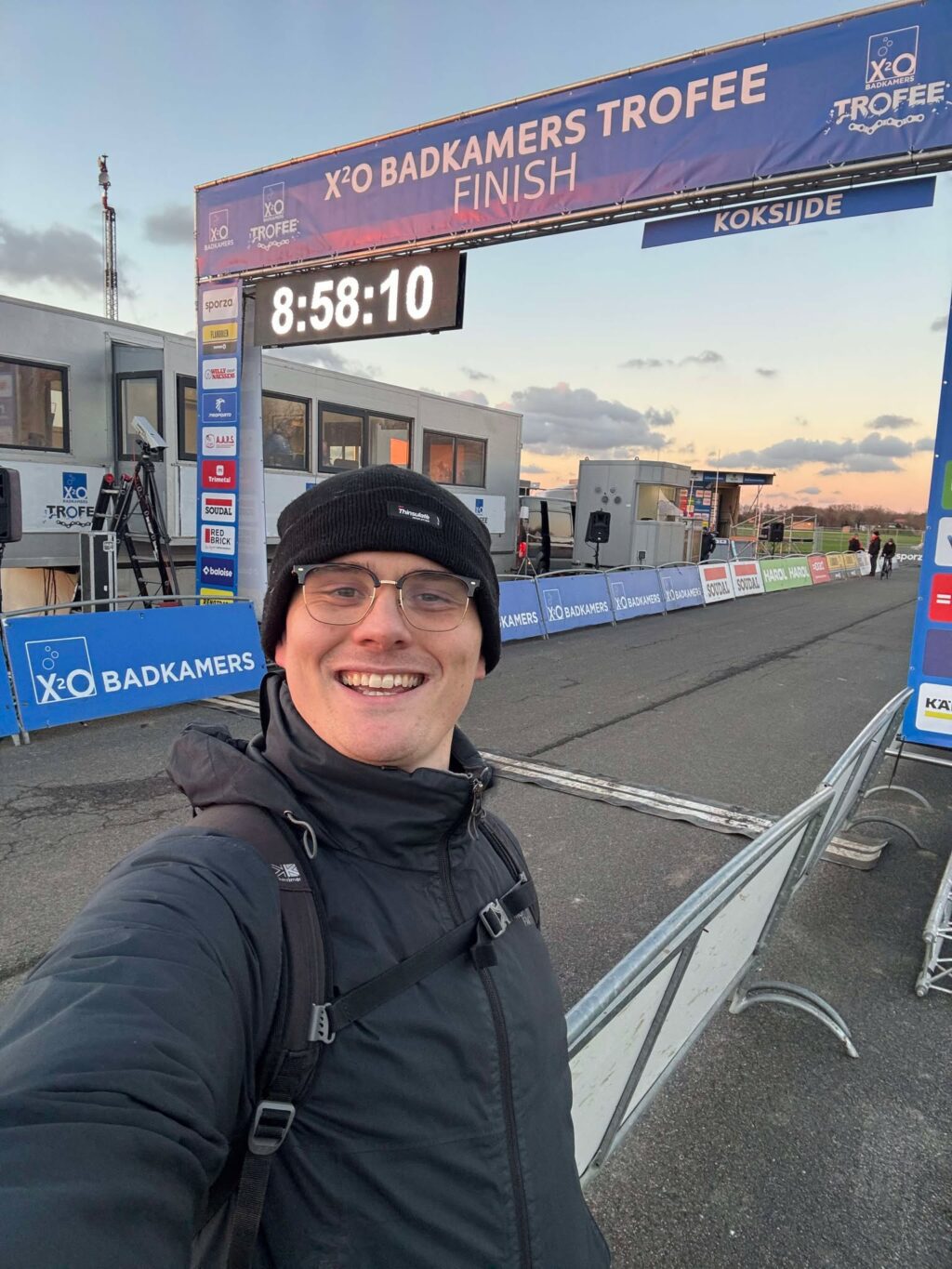 A cycling fan standing on the finish line of a cyclocross race