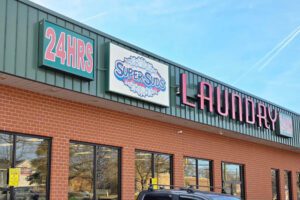 A photo of signage outside a laundromat: "24 hours, SuperSuds,laundry."