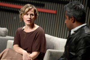 A photo of Jennifer Pahlka speaking to Anand Giridharadas onstage at a conference.